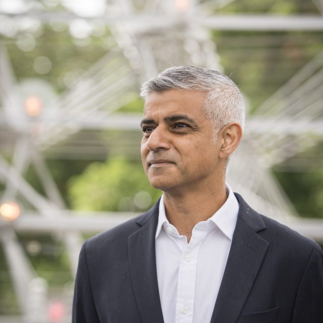 Image of a man, Sadiq Khan, wearing a suite and looking into the distance.