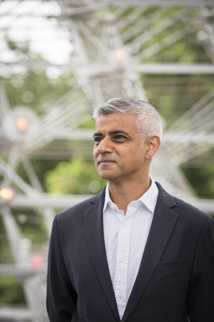 Image of a man, Sadiq Khan, wearing a suite and looking into the distance.